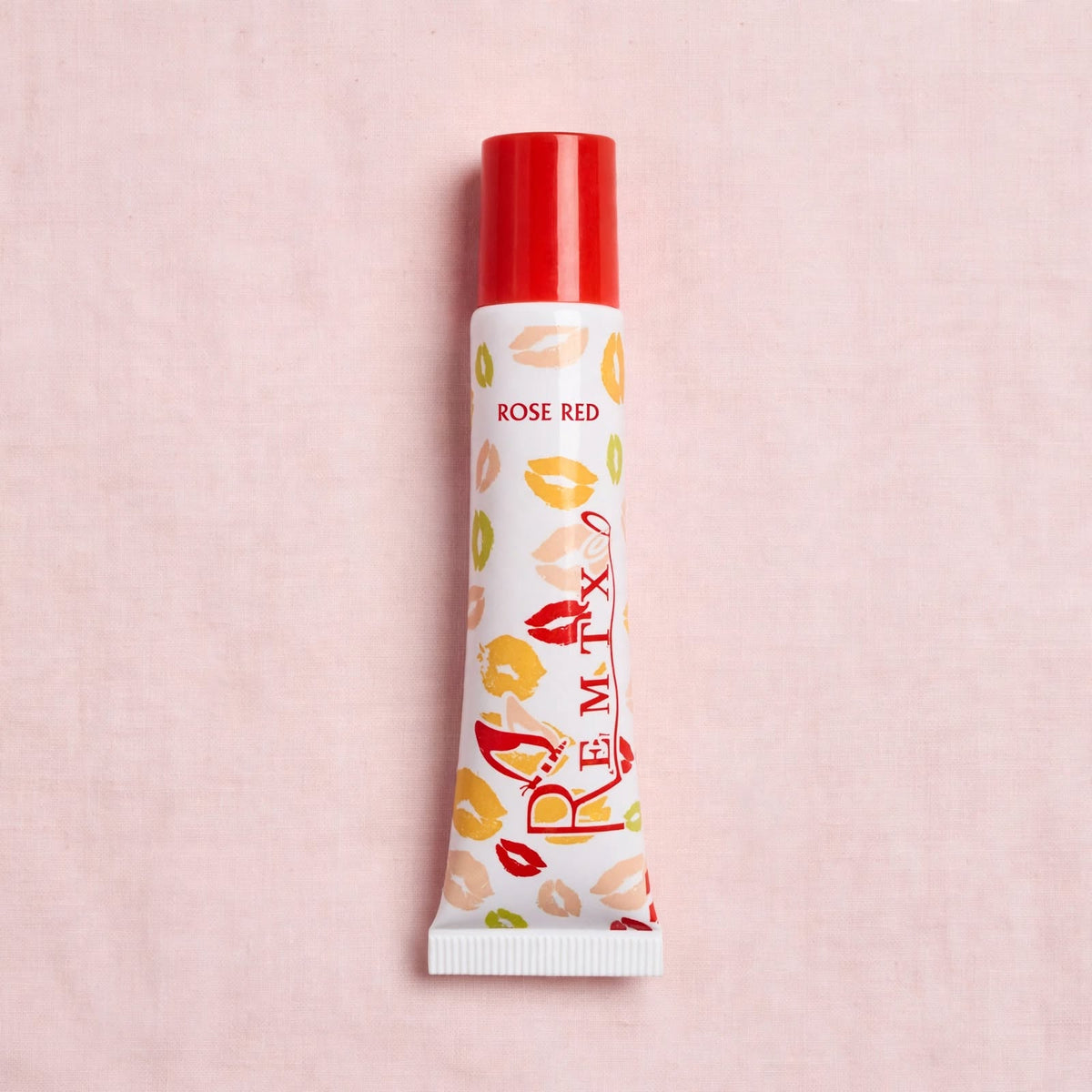 Remtx Rose Red lip gloss on pink