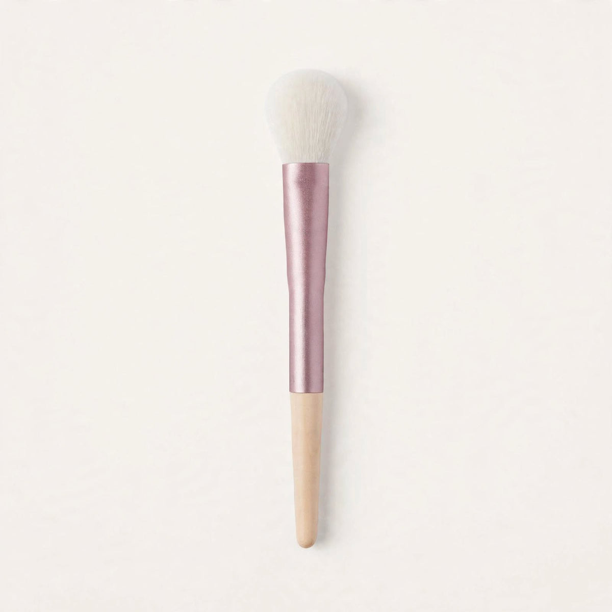 Pink and cream fluffy powder brush standing