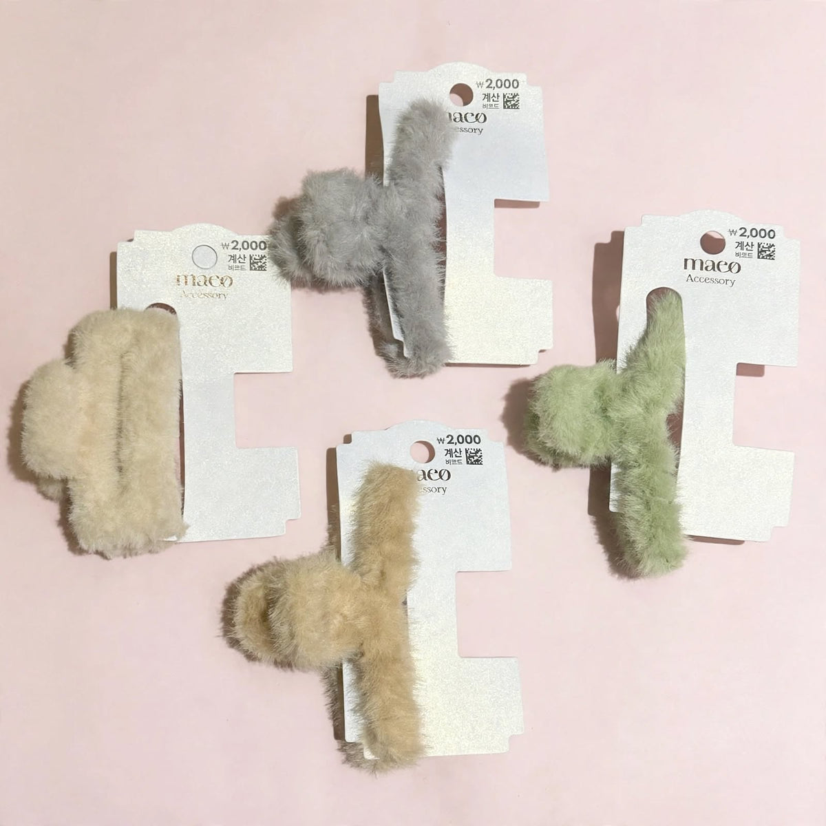 Plush hair claw clips on a pink background