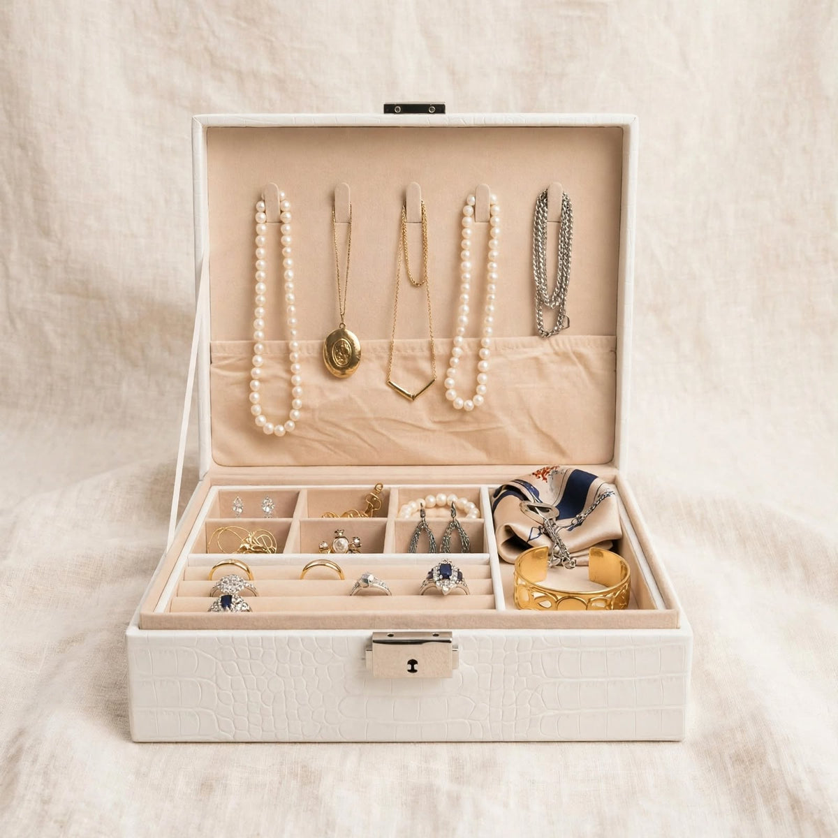 White jewellery box with necklaces and rings