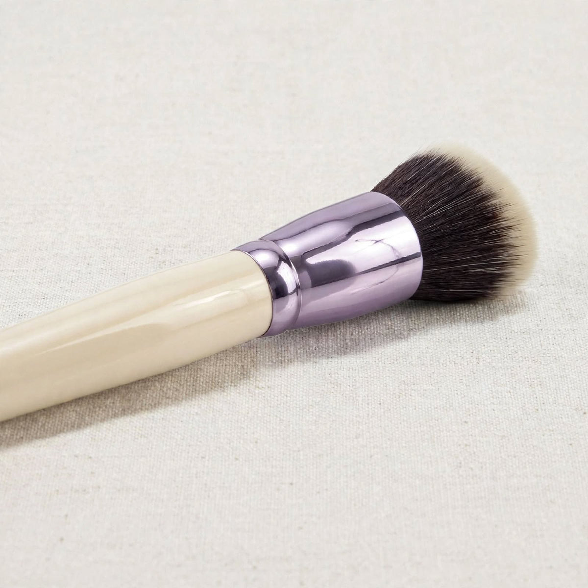 Cream handle powder brush with lilac ferrule, close up