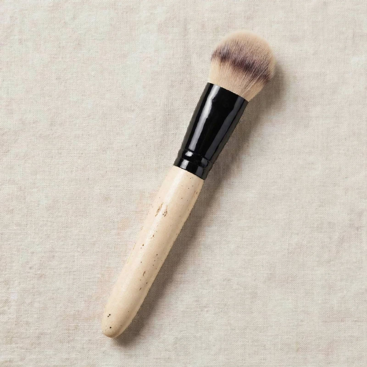 Natural wood buffing brush lying flat