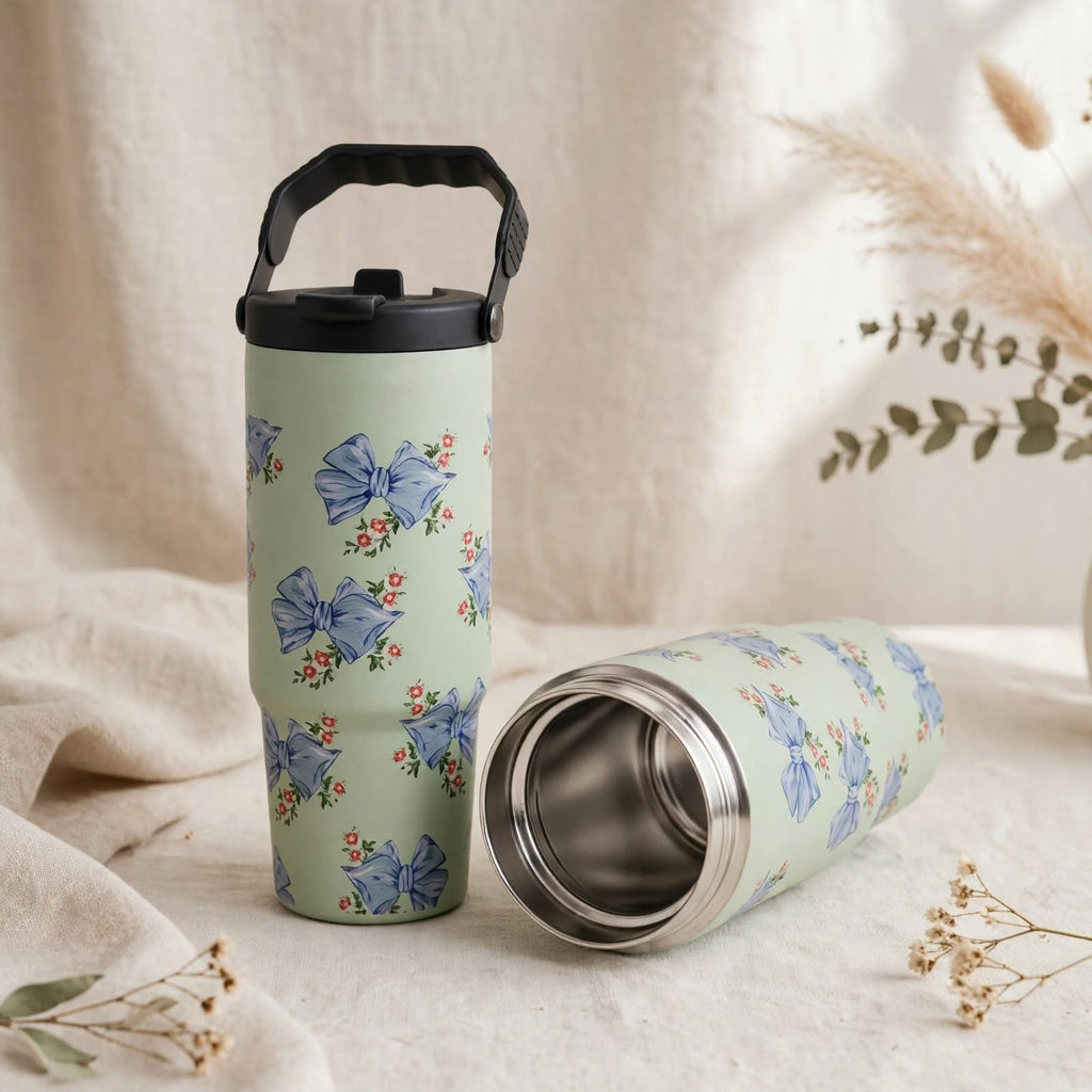 Sage green travel tumbler with blue bows and steel cup